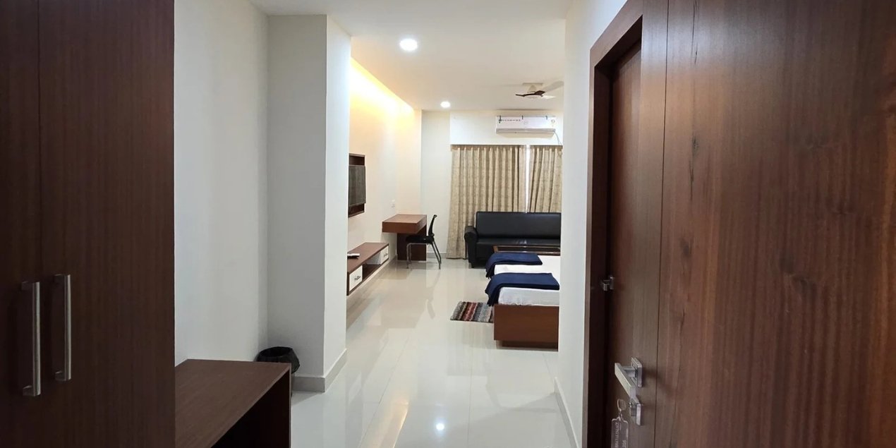 Well-lit, comfortably designed hotel room interior with warm ambience at Binayak Palace Premium